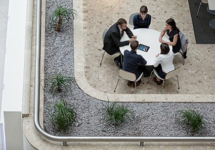 A group of people sat outside working A group of people sat outside working