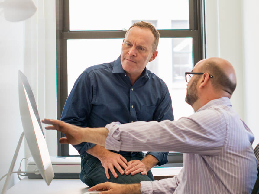 two men looking at a screen two men looking at a screen